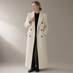Woman wearing the long double-breasted wool coat, wide lapel, three-quarter view, studio