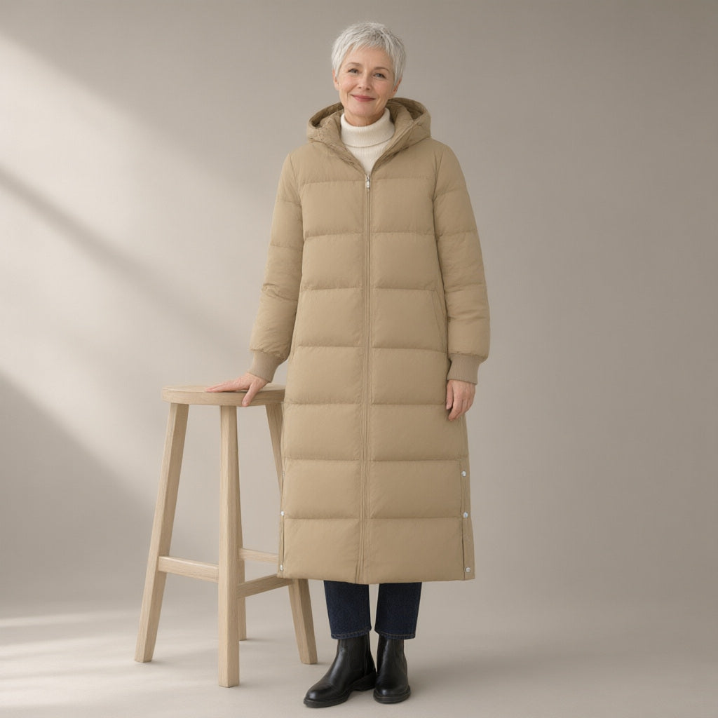 Woman wearing the long hooded puffer coat, over the knee, full length, studio