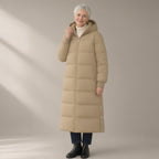 Woman wearing the long hooded puffer coat, over the knee, three-quarter view, studio
