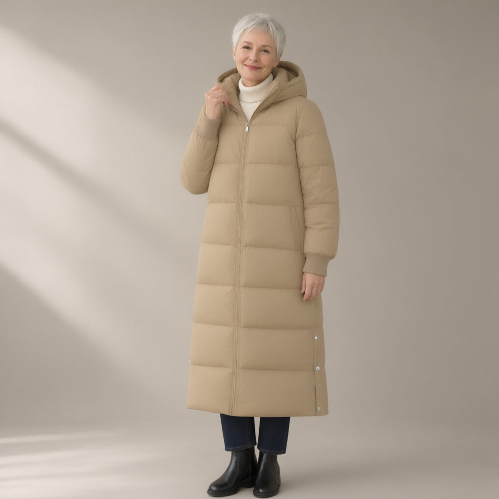 Woman wearing the long hooded puffer coat, over the knee, three-quarter view, studio
