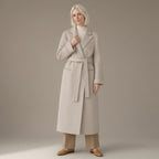Woman wearing the longline tie-waist wool coat, double-faced, full length, studio
