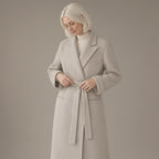 Woman wearing the longline tie-waist wool coat, double-faced, three-quarter view, studio