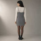 Woman seen from behind wearing the merino-blend knit camisole dress, back view