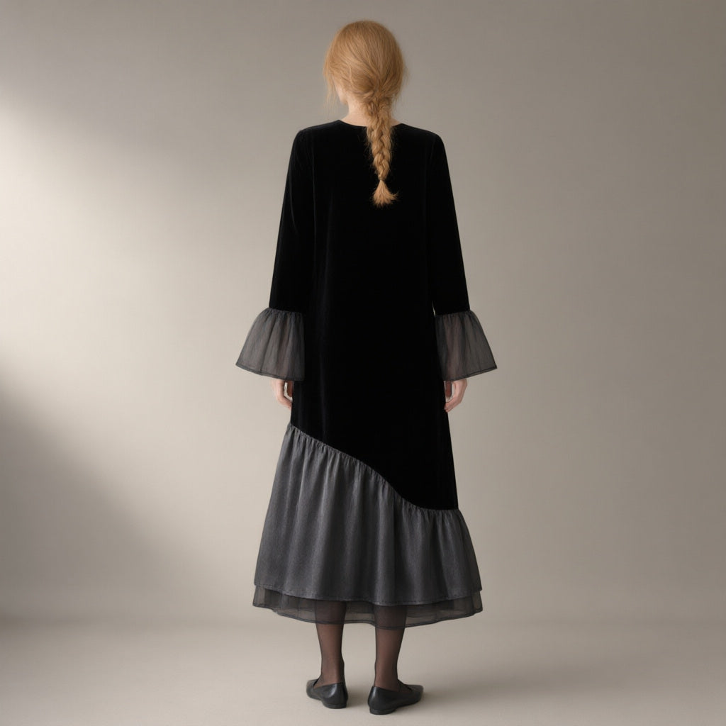 Woman seen from behind wearing the mesh hem velvet midi dress, flared sleeve – black, back view