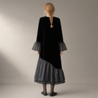 Woman seen from behind wearing the mesh hem velvet midi dress, flared sleeve – black, back view