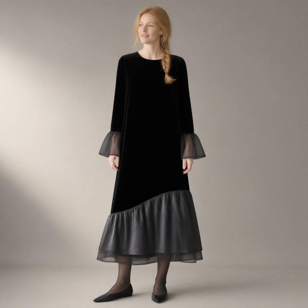 Woman wearing the mesh hem velvet midi dress, flared sleeve – black, three-quarter view, studio