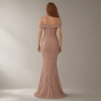 Woman seen from behind wearing the one-shoulder sequin mermaid evening gown – rose gold, back view