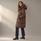 Woman wearing the over-the-knee hooded puffer coat, three-quarter view, studio
