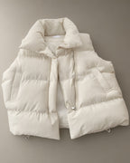 Women’s Short Padded Gilet – Cream, Black or Mocha, laid flat on a stone backdrop