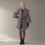 Woman wearing the hooded patchwork coat with knit cuffs, tie belt, full length, studio
