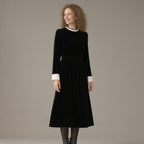 Woman wearing the pearl collar velvet midi dress, long sleeve – black, three-quarter view, studio