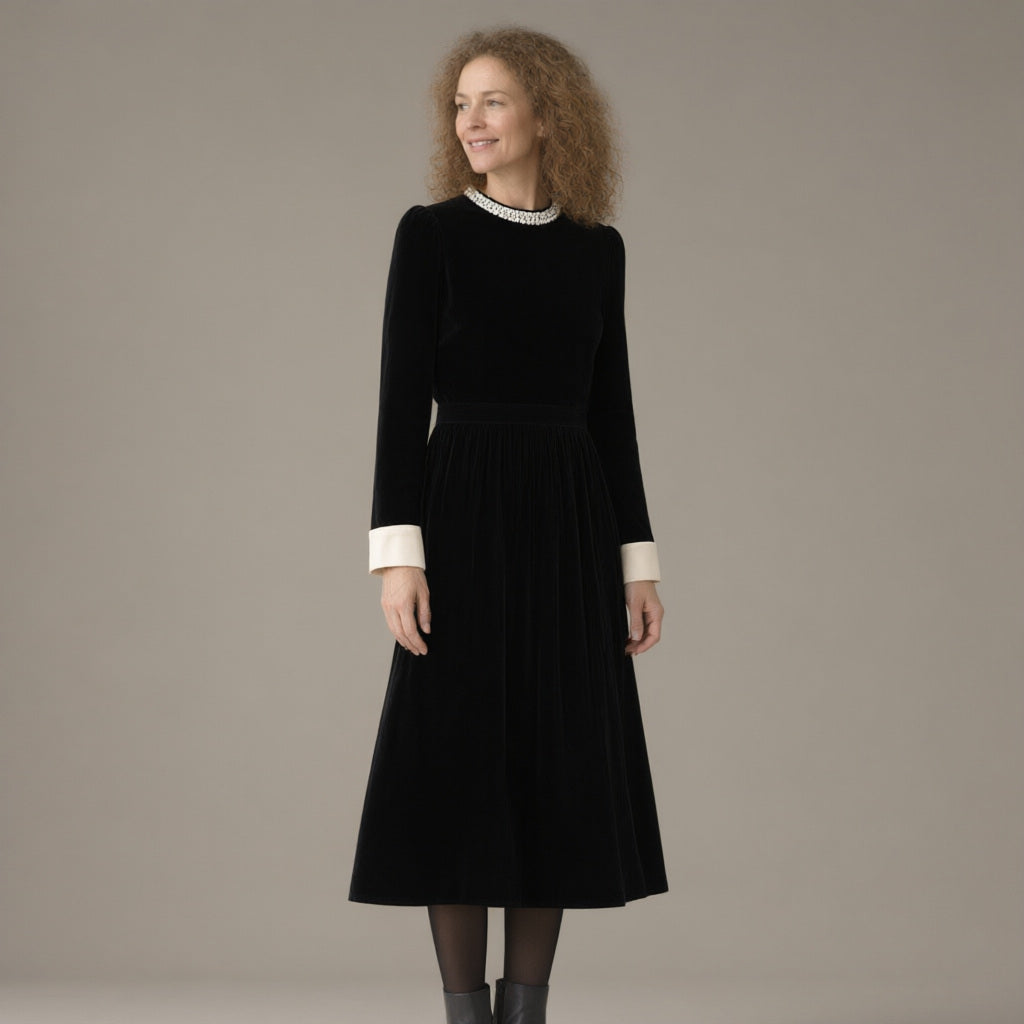 Woman wearing the pearl collar velvet midi dress, long sleeve – black, three-quarter view, studio
