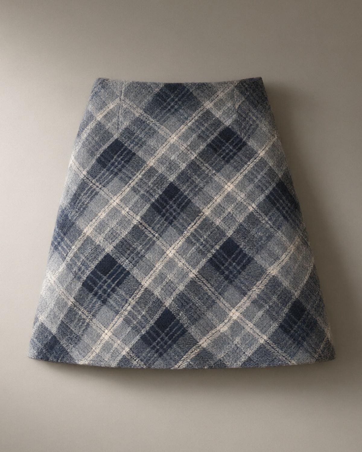 Women’s Plaid A-Line Mini Skirt, Brushed Check Weave, laid flat on a stone backdrop