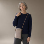 Woman wearing the plush crossbody phone bag, full length, studio