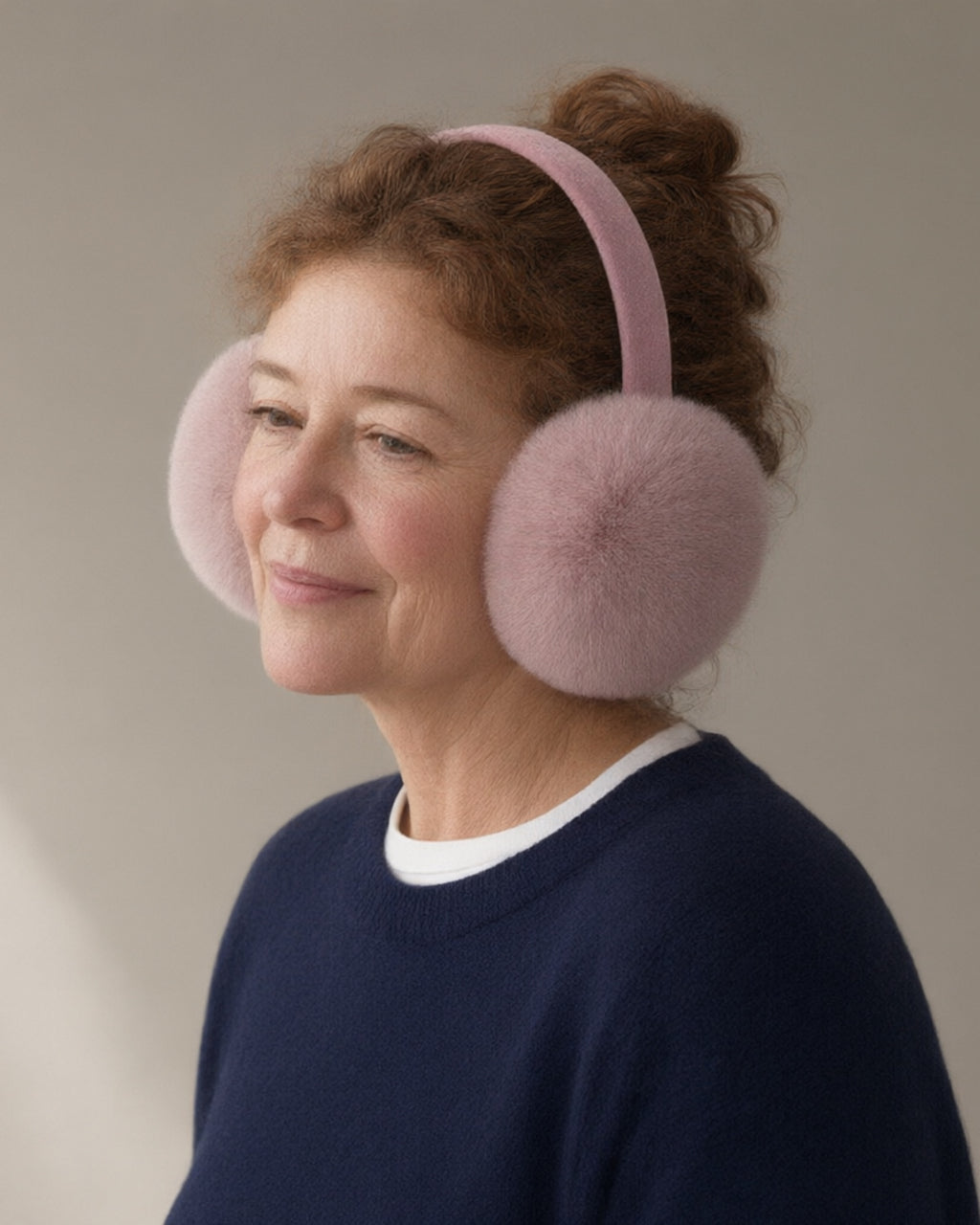Woman wearing the plush earmuffs, three-quarter view, studio