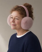 Woman wearing the plush earmuffs, three-quarter view, studio
