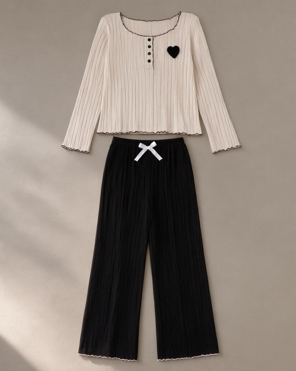 Women’s Ribbed Knit Lounge Set, laid flat on a stone backdrop