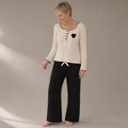 Woman wearing the ribbed knit lounge set, three-quarter view, studio