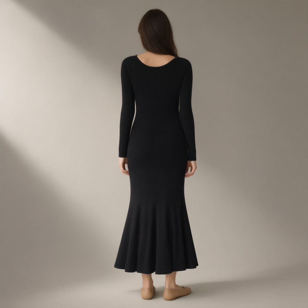 Woman seen from behind wearing the ribbed knit midi dress, v-neck long sleeve – black, back view