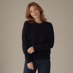 Woman wearing the wool jumper, round neck, 100% wool, three-quarter view, studio