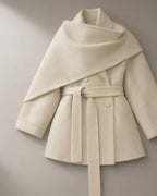 Women’s Shawl Collar Belted Wool Coat, laid flat on a stone backdrop