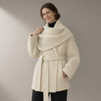 Woman wearing the shawl collar belted wool coat, three-quarter view, studio