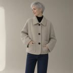 Woman wearing the shirt collar wool jacket, single-breasted, three-quarter view, studio
