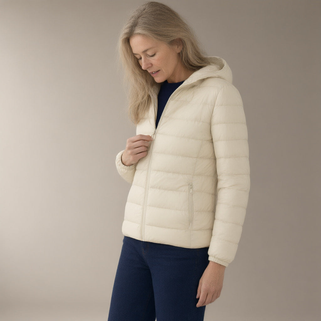 Woman wearing the short hooded down jacket – 90% duck down, three-quarter view, studio