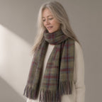Woman wearing the tasselled plaid scarf, 200 x 50cm, three-quarter view, studio