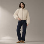 Woman wearing the teddy fleece jacket, zip stand collar, full length, studio