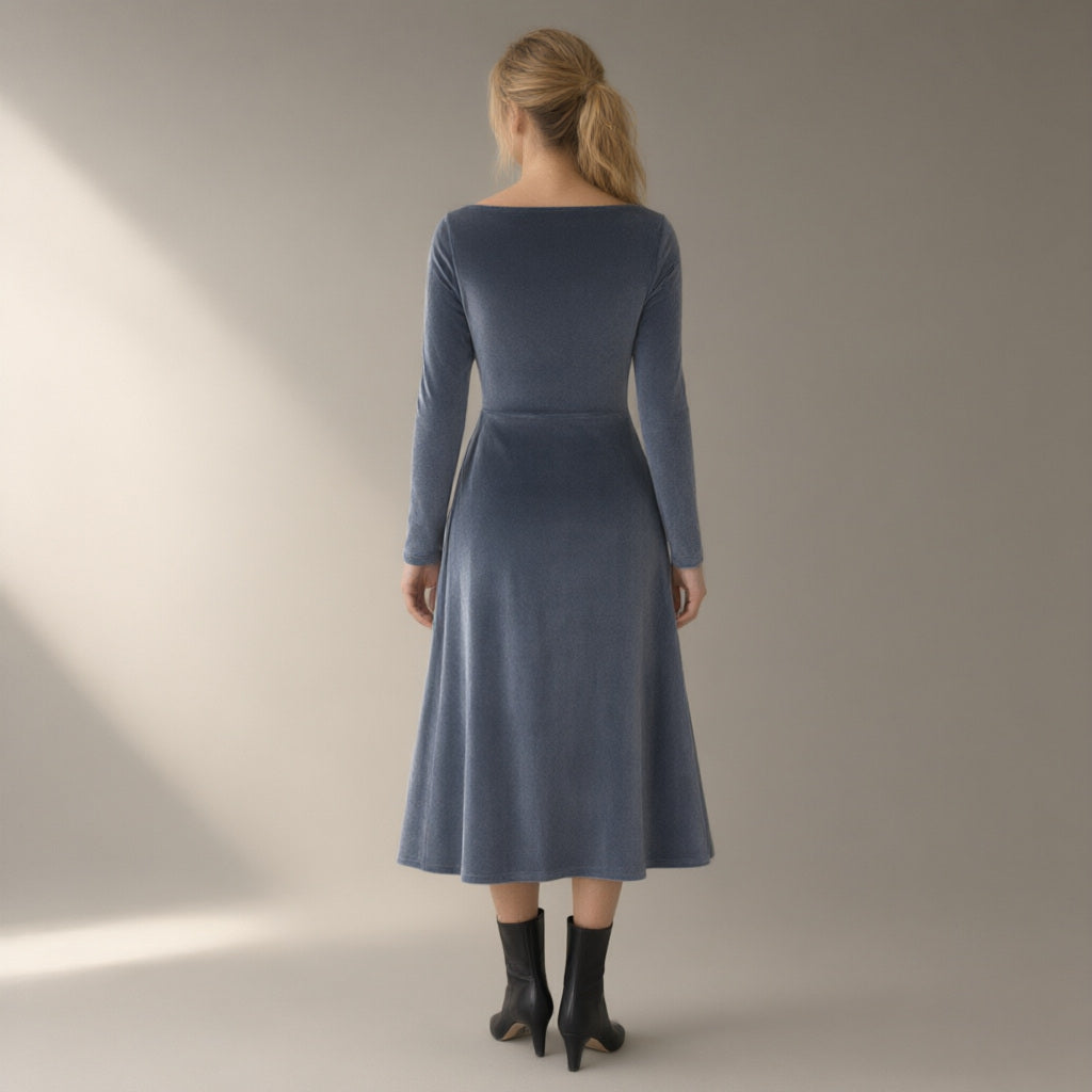Woman seen from behind wearing the twist-waist velvet evening dress, long sleeve – slate grey, back view