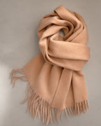 Women’s Wool Scarf with Fringe, 32 x 180 cm, laid flat on a stone backdrop