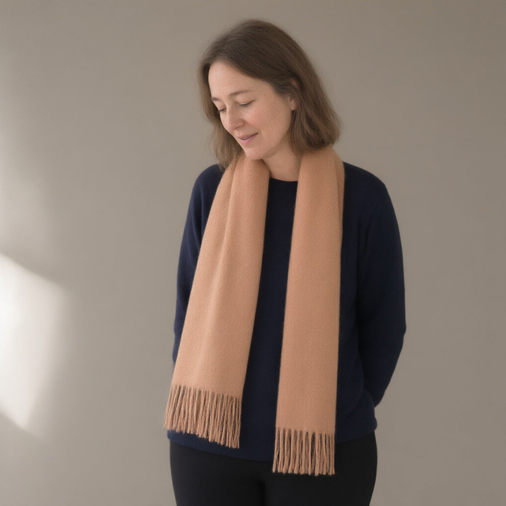 Woman wearing the wool scarf with fringe, 32 x 180 cm, three-quarter view, studio
