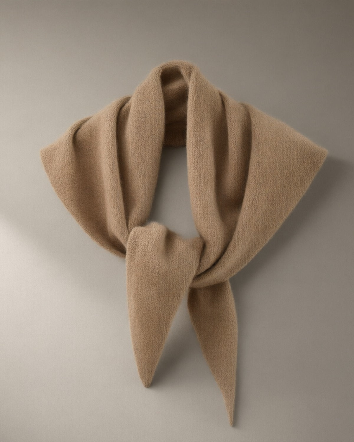 Women’s Wool Triangle Scarf, 100% Wool, laid flat on a stone backdrop
