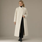 Woman wearing the long wrap coat, stand collar & tie belt, full length, studio