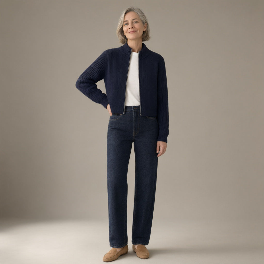 Woman wearing the zip-up ribbed knit cardigan, stand collar – navy, full length, studio
